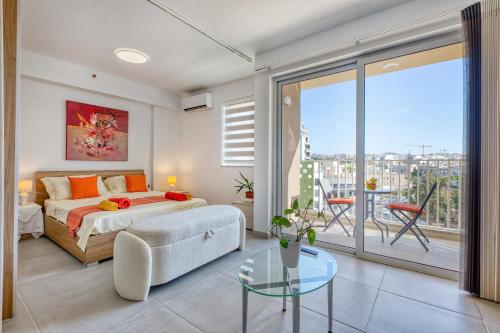 a bedroom with a bed and a glass table at Stunning Studio Heart of St Julians Sleeps 4 in San Pawl il Bahar