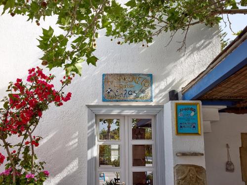 a white building with a window and a sign above it at Grecotel Creta Palace in Rethymno Town