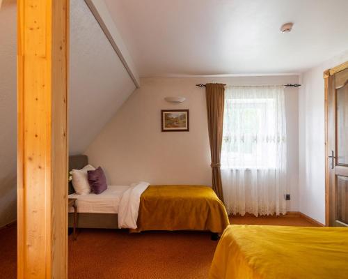 a bedroom with two beds and a window at Slėnis Trakuose in Trakai