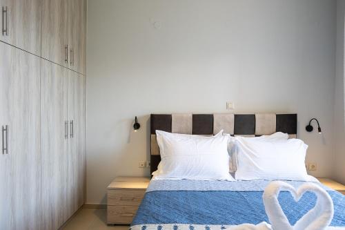 a bedroom with a bed with white pillows at Sophias View in Loutra