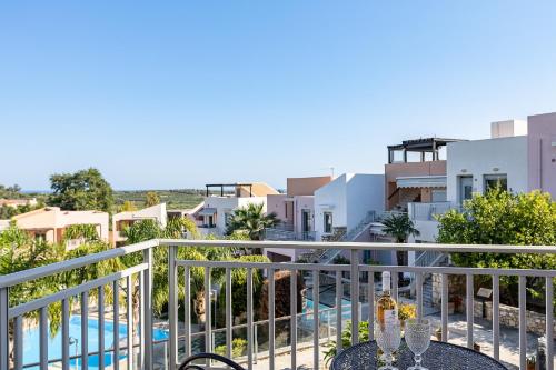 a balcony with a view of a pool and buildings at Sophias View in Loutra