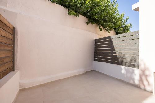 a corner of a room with a wall with a plant at Sophias View in Loutra