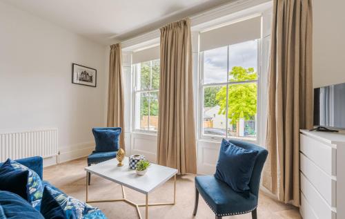 a living room with a couch and chairs and a table at Elegant 2BR Ground-Floor Teddington Flat Modern Comfort in Kingston upon Thames