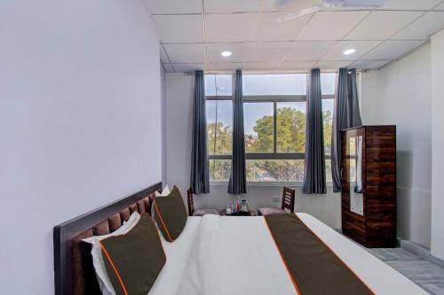 a bedroom with a large bed and a window at Hotel O Connect in Jaipur