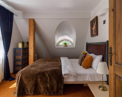 a bedroom with a large bed with a window at Slėnis Trakuose in Trakai