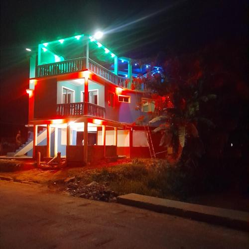 a house with lights on it at night at La maison des couleurs in Sabaneta de Yásica