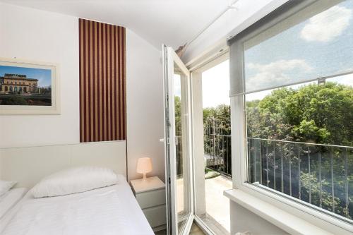 a bedroom with a bed and a large window at Hotel am Park in Braunschweig