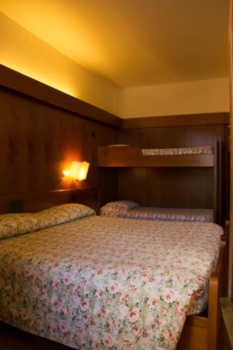 a bedroom with two beds in a room at Hotel Carlone in Breguzzo