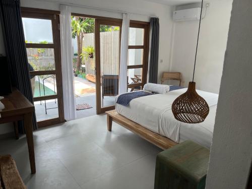 a bedroom with a bed and a pendant light at Nextdoor Rooms in Yogyakarta