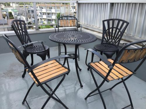 a group of chairs and a table on a balcony at TOKYOtomo in Wada