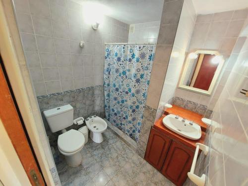 a small bathroom with a toilet and a sink at Complejo Lago Chico in Tanti