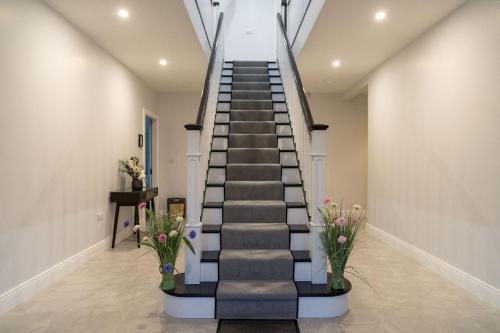a spiral staircase in a house with flowers at Willow Valley in Monaghan
