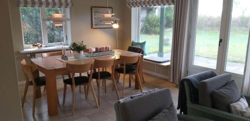 a living room with a table and chairs and a couch at Reethaus-am-Strand in Südstrand