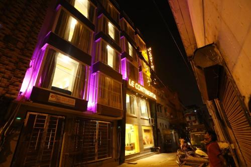 a building with purple lights on the side of it at Le continental in New Delhi