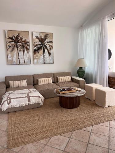 a living room with a couch and a coffee table at Villa Atenea by Aura Villas in Charco del Palo