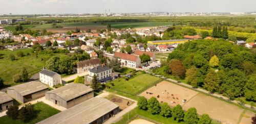 an aerial view of a town with buildings and trees at Auberge du Chateau Bleu in Tremblay En France
