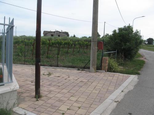 a brick sidewalk next to a road with a fence at La casa di Nana' 1 in Casalbordino