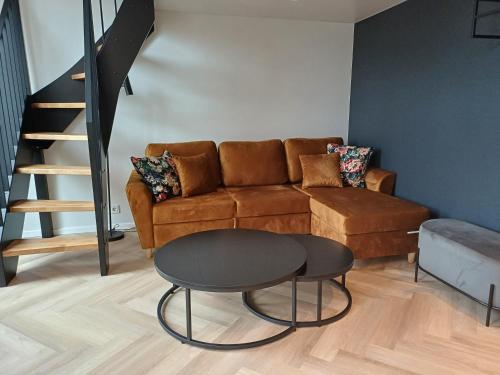 a living room with a couch and a table at Luise LuXe Suites in Tallinn
