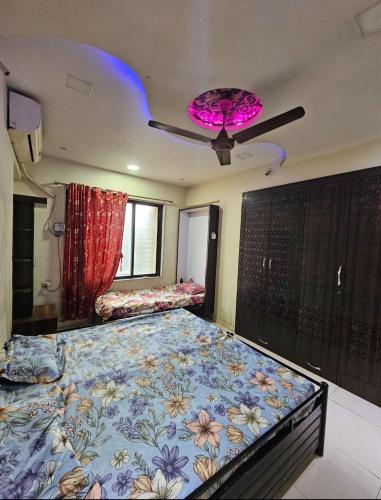 a bedroom with a large bed with a blue blanket at Ac Private Room At Ovale Naka thane West in Jāmb