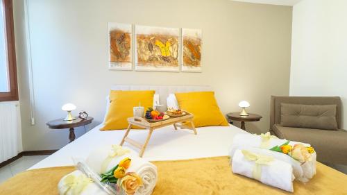 a bedroom with a bed with a tray of food on it at Dimora Sotto le Stelle by Ca-Sa Check in Chioggia