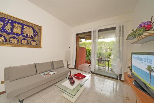 a living room with a couch and a flat screen tv at Il fiordaliso Blu in Desenzano del Garda