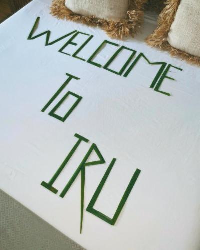 a white cake with the words make it real at Iru Maldives in Thulusdhoo