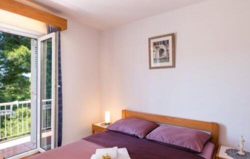 a bedroom with a bed and a large window at Villa Tina Crikvenica by Villas Guide in Crikvenica