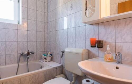 a bathroom with a tub and a toilet and a sink at Villa Tina Crikvenica by Villas Guide in Crikvenica