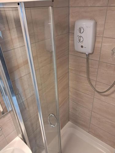 a shower with a glass door in a bathroom at Saint Annes Guest House - 22 Berkeley in Dublin