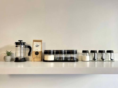a shelf with pots and pans and a coffee maker at Dream in Tbilisi City