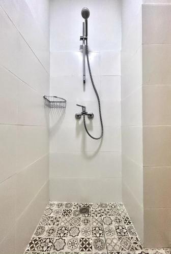a bathroom with a shower with a tiled floor at Dream in Tbilisi City