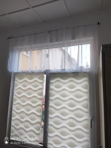 a window with a curtain and a sliding door at Appartement mit Garten zentrumnah in Schwerin