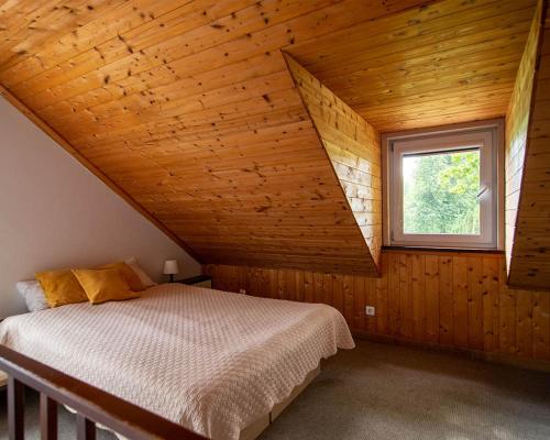a bedroom with a bed in a room with a window at Slėnis Trakuose in Trakai