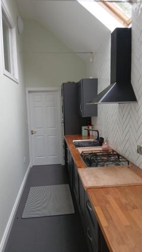 a kitchen with a counter top and a stove at Port Omna Ciúin in Portumna