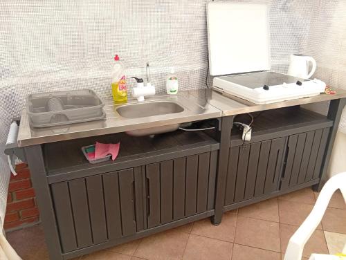 a kitchen counter with a sink and a mirror at Villa Maria in Opatija