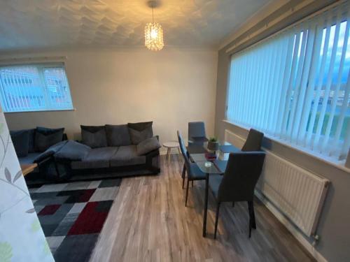a living room with a couch and a table at Spacious Luxurious Serviced Accommodation 3 in Warmsworth