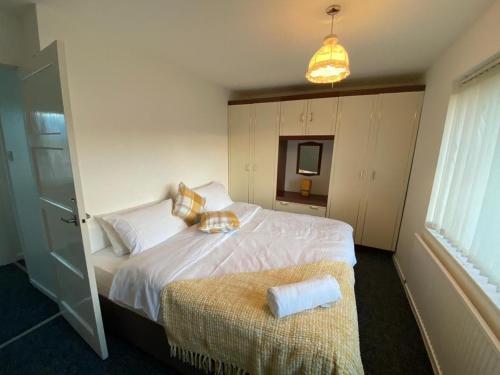 a bedroom with a large white bed and a window at Spacious Luxurious Serviced Accommodation 3 in Warmsworth