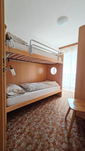 a bedroom with two bunk beds in a room at Appartamenti Bernard Sas in Canazei