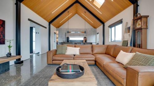 a living room with a couch and a table at Lake Hood Escape & Private Jetty in Ashburton