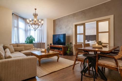 a living room with a couch and a table at STING Boutique Apartments in Ostrava