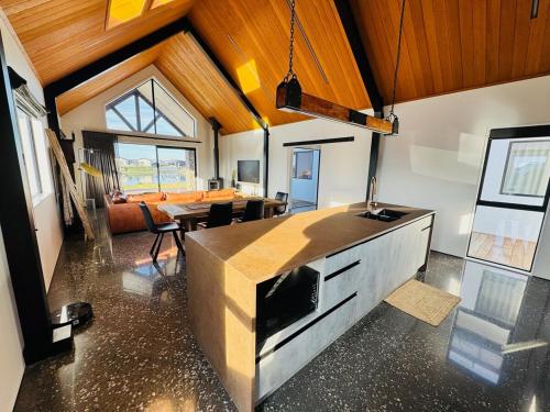 a kitchen and dining room with a dining table at Lake Hood Escape & Private Jetty in Ashburton