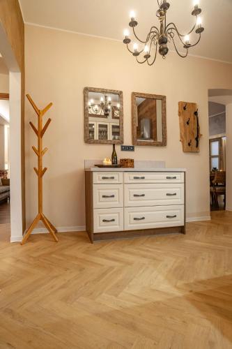 a living room with a dresser and a mirror at STING Boutique Apartments in Ostrava