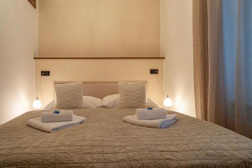 a large bed with two pillows on top of it at STING Boutique Apartments in Ostrava