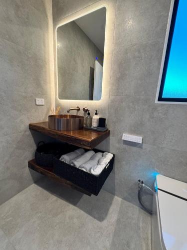a bathroom with a sink and a mirror at Lake Hood Escape & Private Jetty in Ashburton