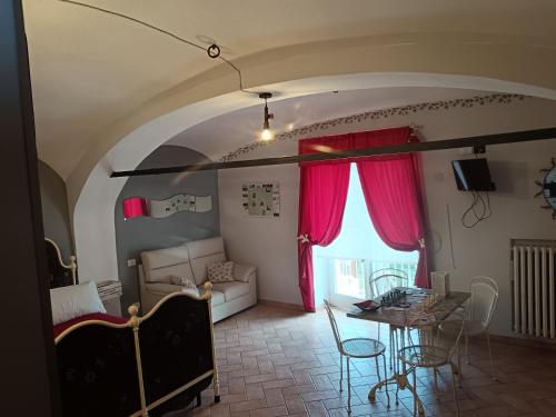 a living room with a table and a dining room at Il Balcone di Napoleone in Narzole