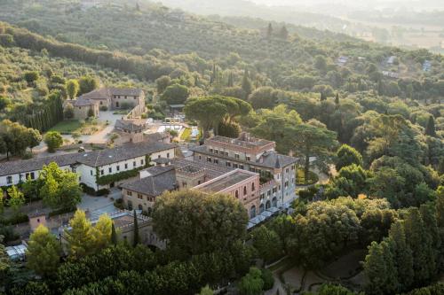 an aerial view of a mansion in a forest at Borgo Dei Conti Resort Relais & Chateaux in Monte Petriolo
