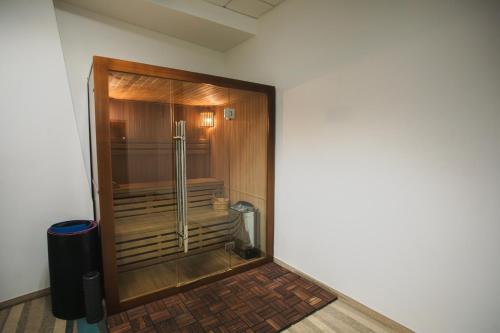 a bathroom with a shower in the corner of a room at Hotel Pogoria Residence in Dąbrowa Górnicza