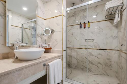 a bathroom with a sink and a shower at Adalya Elite Lara Hotel - Ultra All Inclusive in Lara