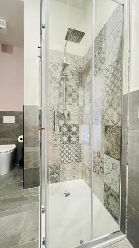 a shower with a glass door in a bathroom at Dietro L'angolo in Gozzano