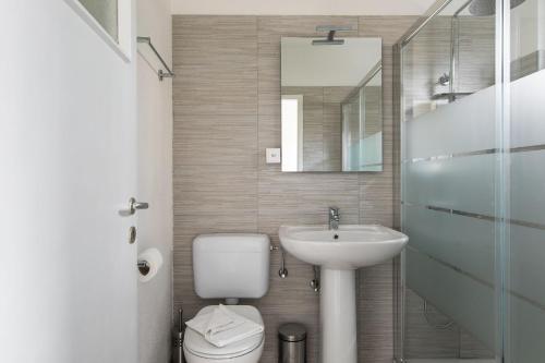 a bathroom with a sink and a toilet and a mirror at Rose 2 Apartment by Quokka 360 - duplex on 2 floors with balcony in Ruvigliana